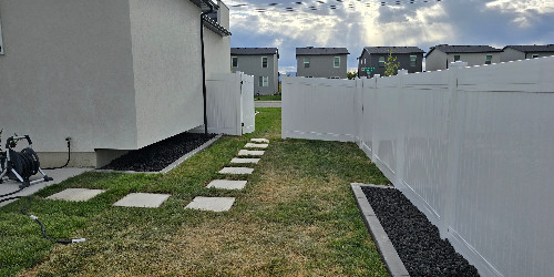 Lush backyard with varied plants and hardscaping